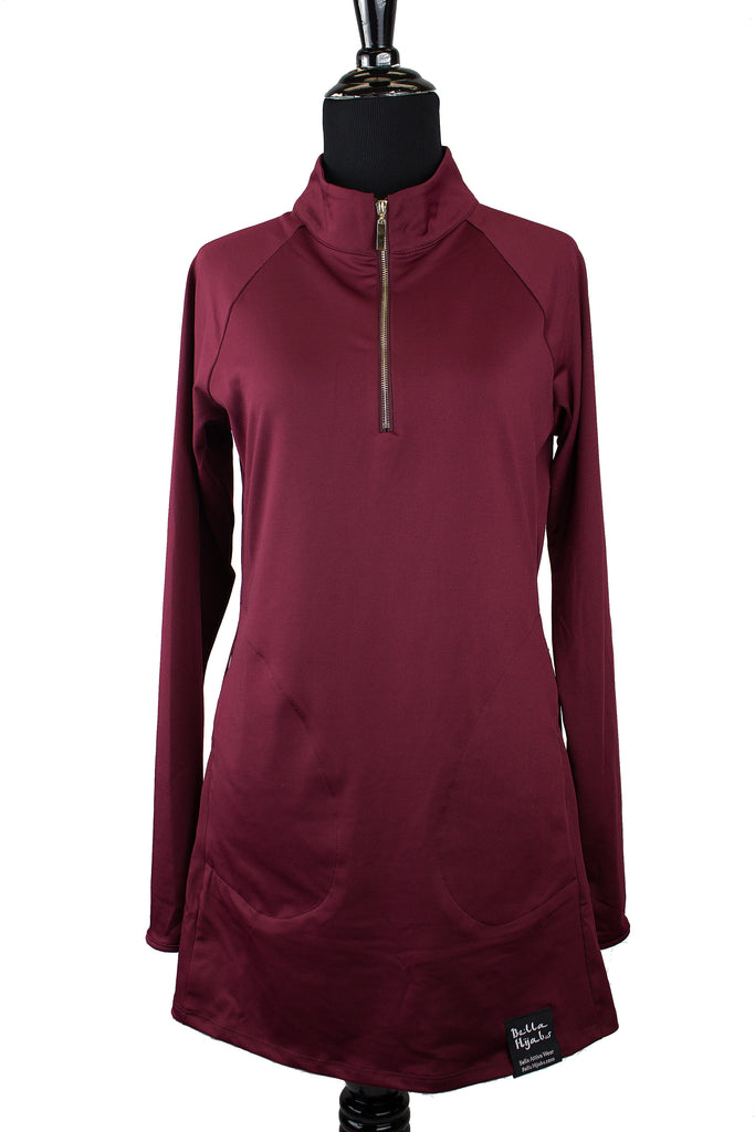long sleeved workout top in maroon with a gold zipper