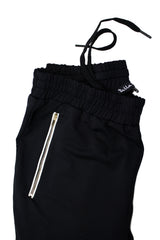 black jogger pants with gold zippers and drawstrings