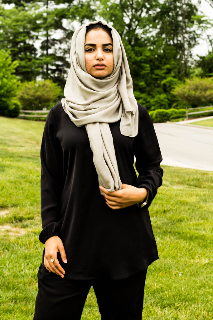 a muslim woman wearing all black and a bamboo hijab in gray