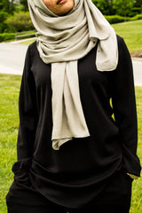 a woman wearing all black and a gray bamboo hijab