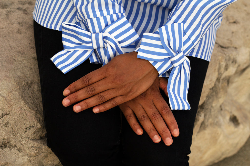 closeup of bow sleeves on a striped blouse