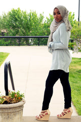 black muslim woman in bow sleeve top in mint and gray lace hijab
