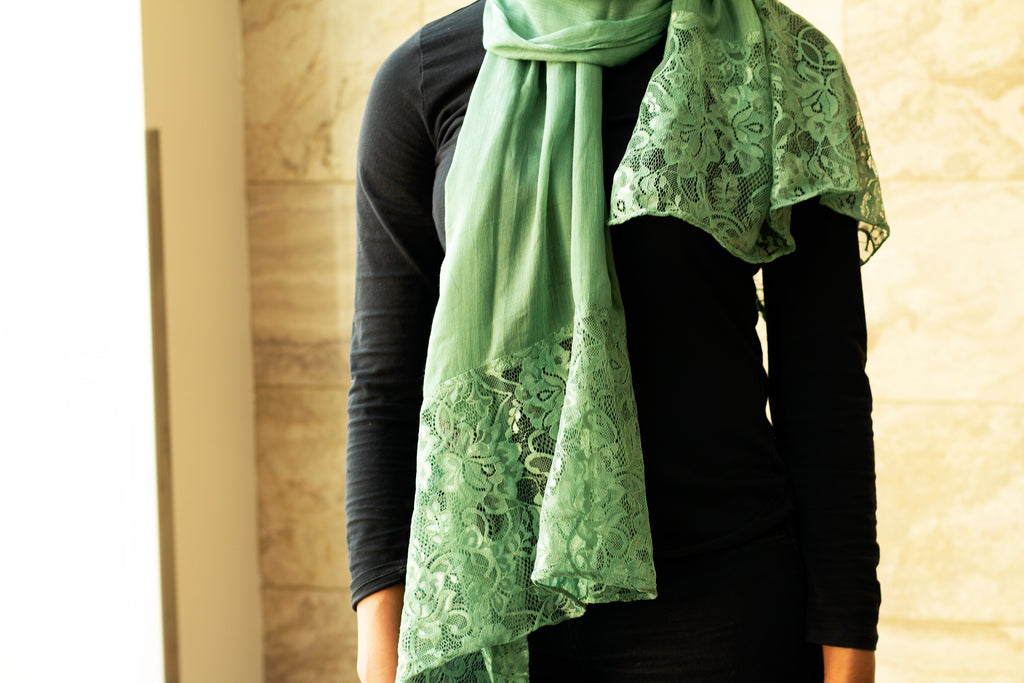 solid light green hijab made with modal fabric and embellished with lace at the ends
