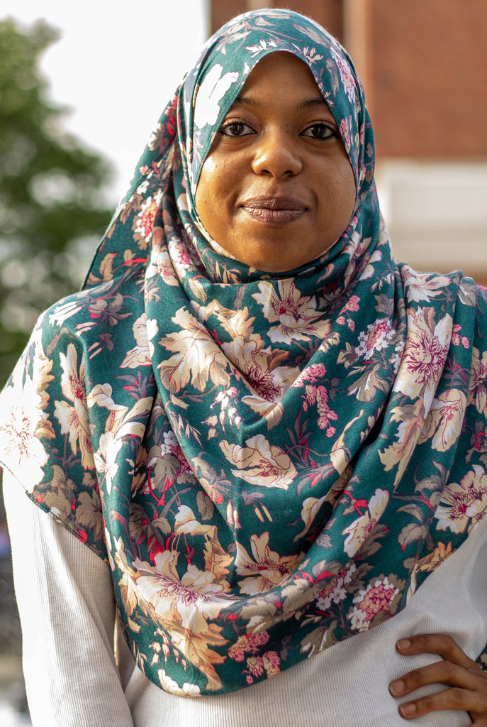 black muslim woman in floral hijab in turquoise and white top