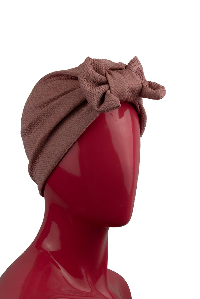 pink slip on turban with a large bow on the front