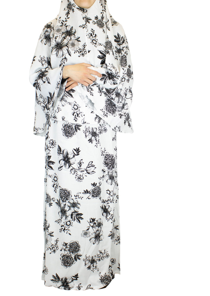 two piece salah outfit with hijab and skirt printed with black and white floral