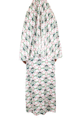 two piece salah outfit with hijab and skirt printed with pink, green, and white floral