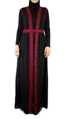 black sleeveless duster with palestinian inspired embroidered detailing and a matching belt