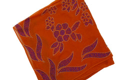 orange square hijab with blue jewels in a floral pattern