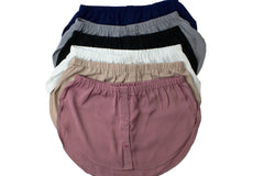 bundle of fake shirt extenders in navy mauve silver black tan and white with buttons and an elastic waistband