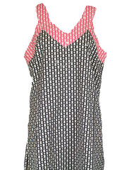 Sleeveless long top that comes to the mid-thigh. Geometric print in white, black, and pink.
