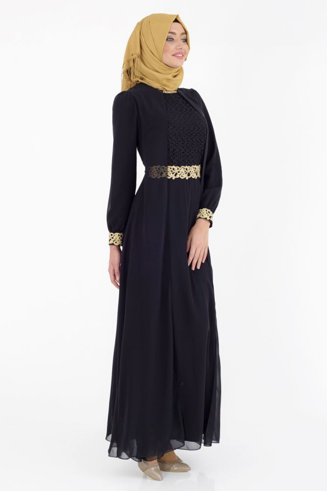 turkish woman wearing a gold hijab an elegant black long sleeve maxi dress with gold embellishments