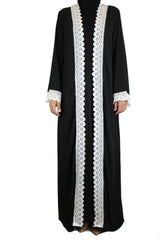 woman wearing an abaya in black embellished with white lace sleeves