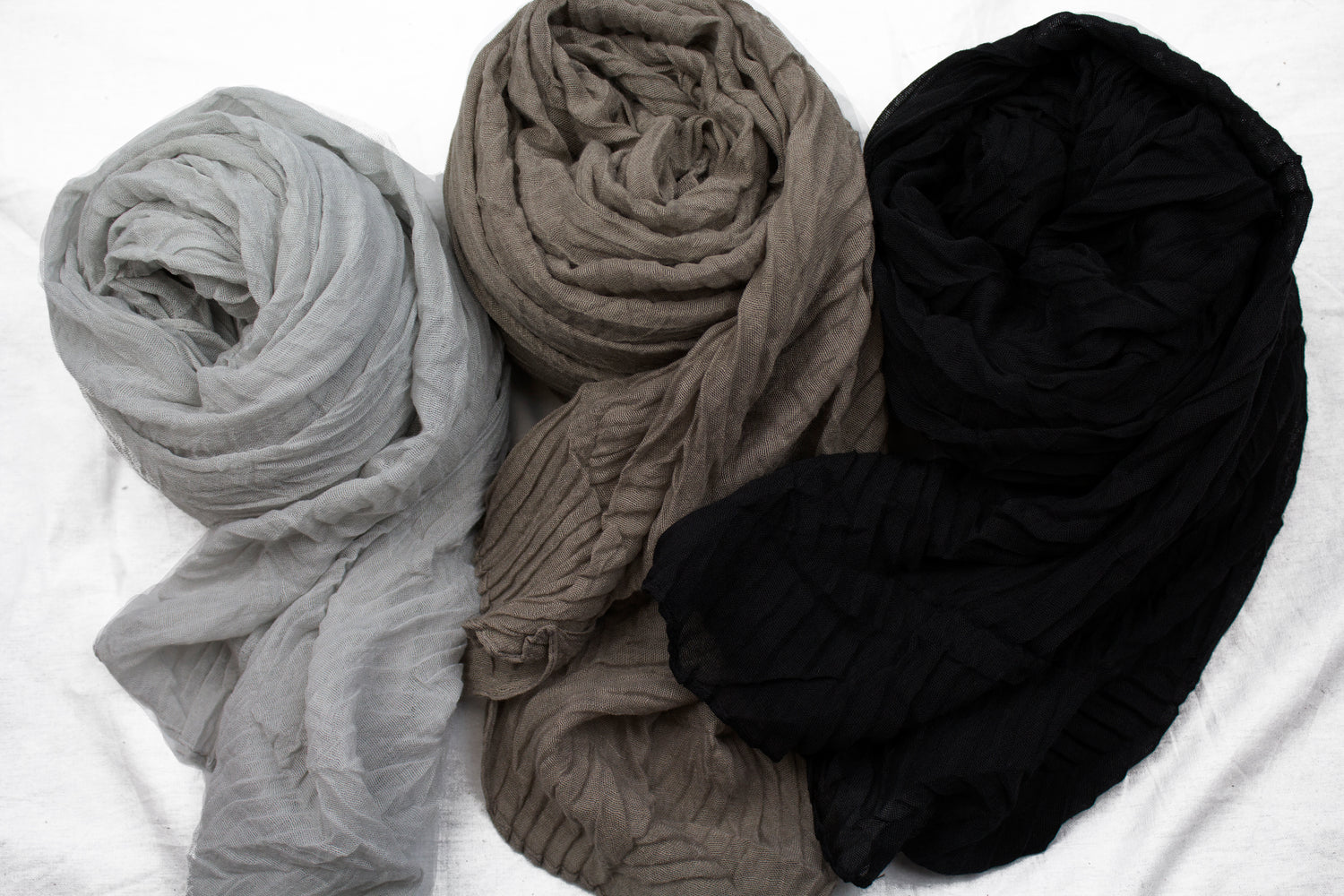 three viscose pleated hijabs in gray taupe and black