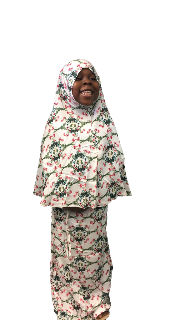 young muslim child wearing prayer set with hijab and skirt