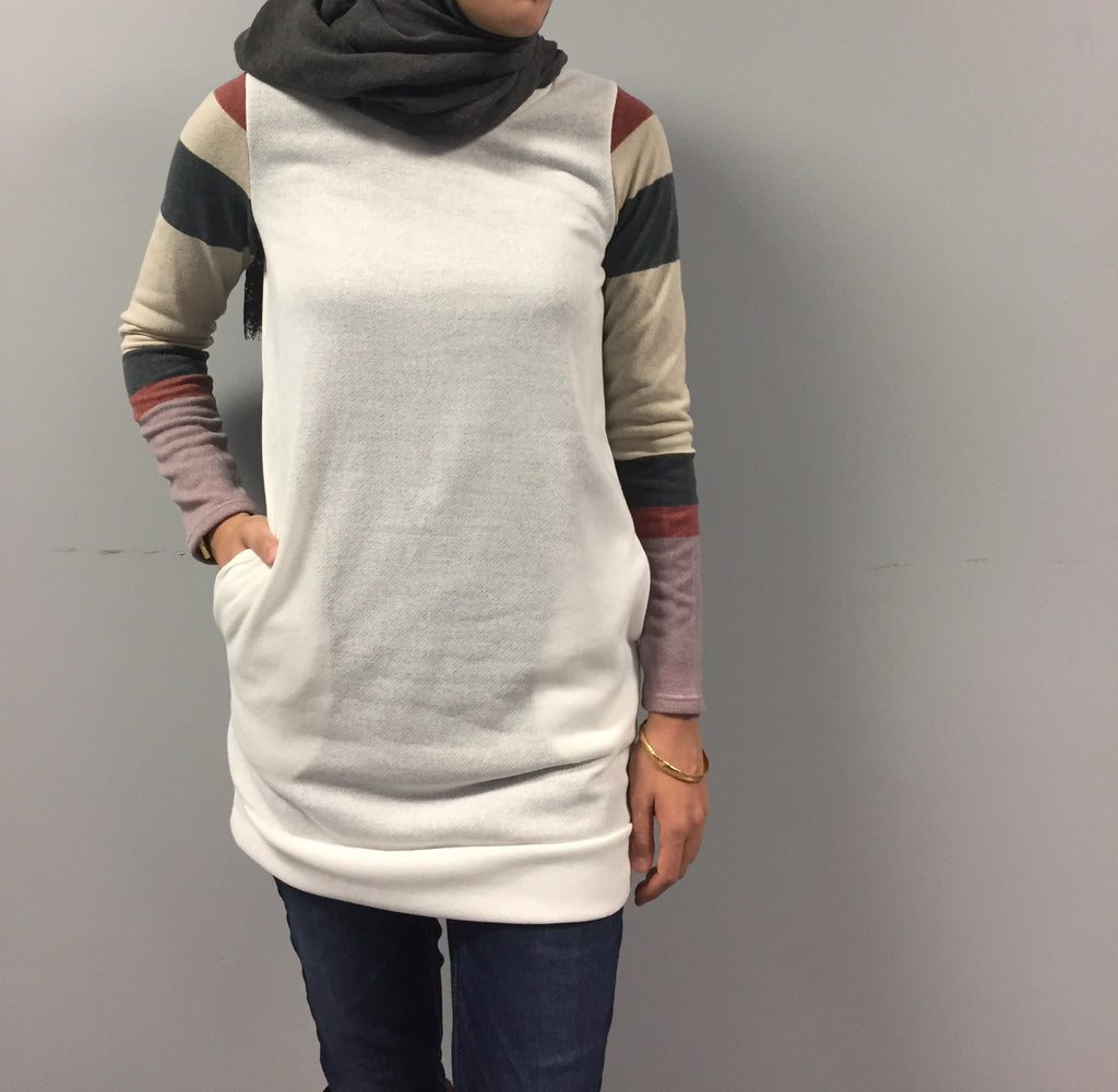 white long sleeved sweater with striped sleeves and pockets