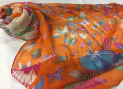 soft orange hijab printed with butterflies in green, pink, red, yellow, purple, and blue