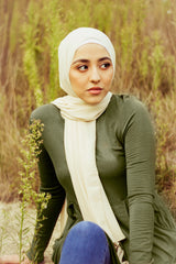 muslim hijabi woman wearing creme chiffon hijab and and long sleeve midi swing baby doll dress in olive green