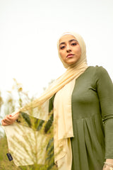 muslim hijabi woman wearing creme chiffon hijab and and long sleeve midi swing baby doll dress in olive green