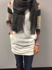 white long sleeved sweater with striped sleeves and pockets