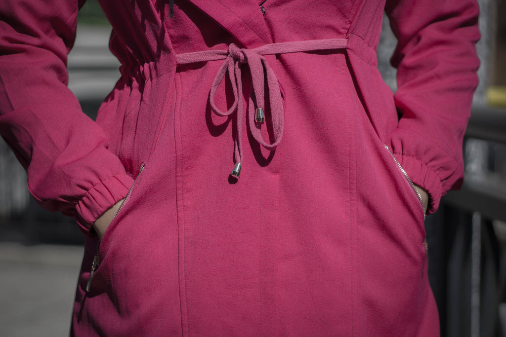 magenta pink open front long sleeve cascade jacket with pockets and zipper closures with a waist tie
