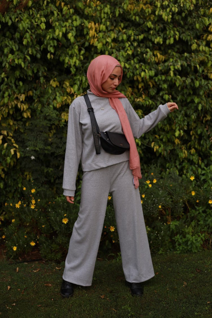 muslim woman wearing a blush mauve pink modal hijab with a gray loungewear set