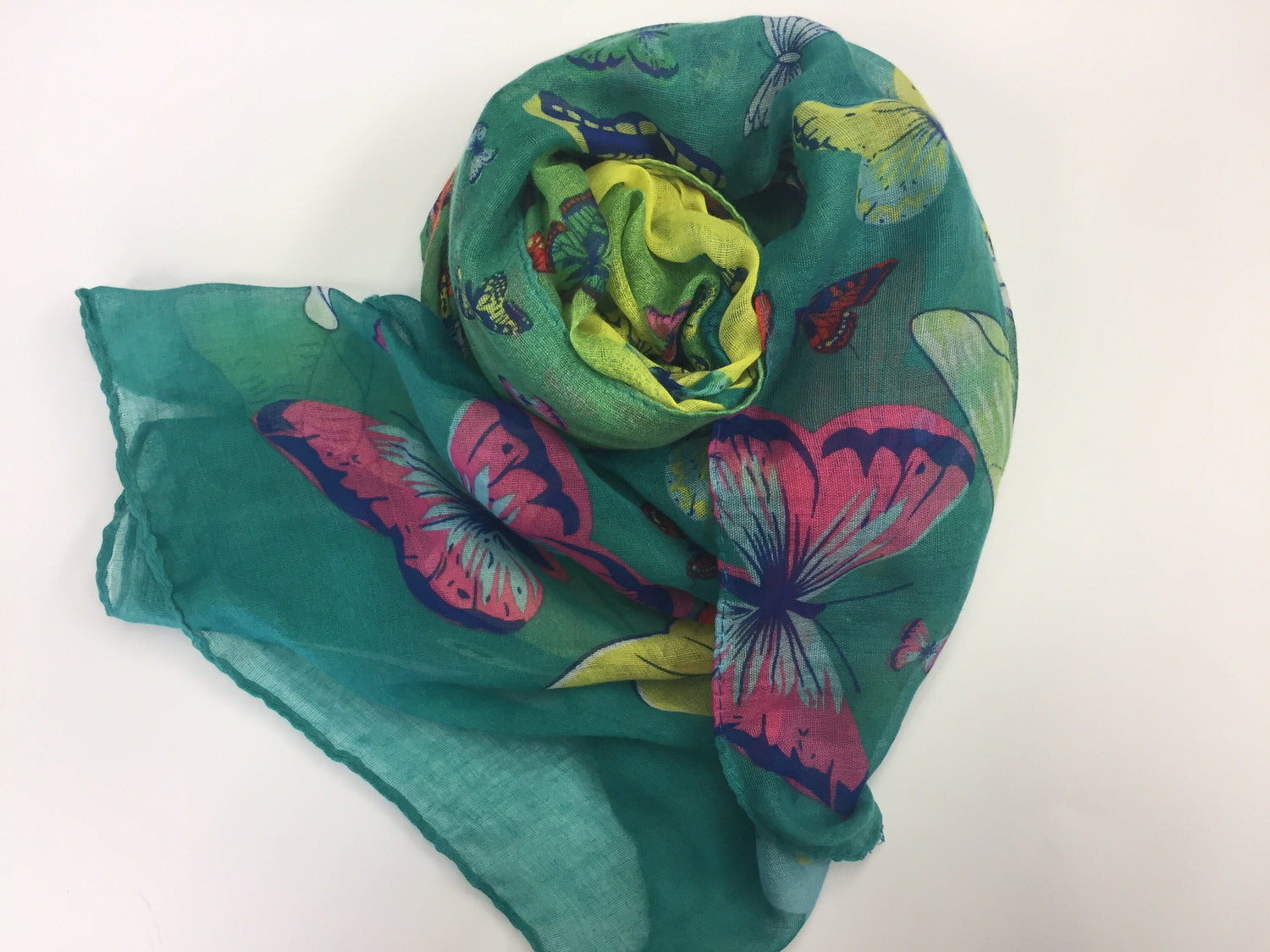 soft turquoise green hijab printed with butterflies in green, pink, yellow, purple, and blue