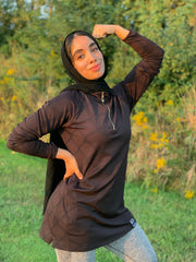 muslim woman wearing hijab and attivo modest half zip long sleeve workout top with pockets