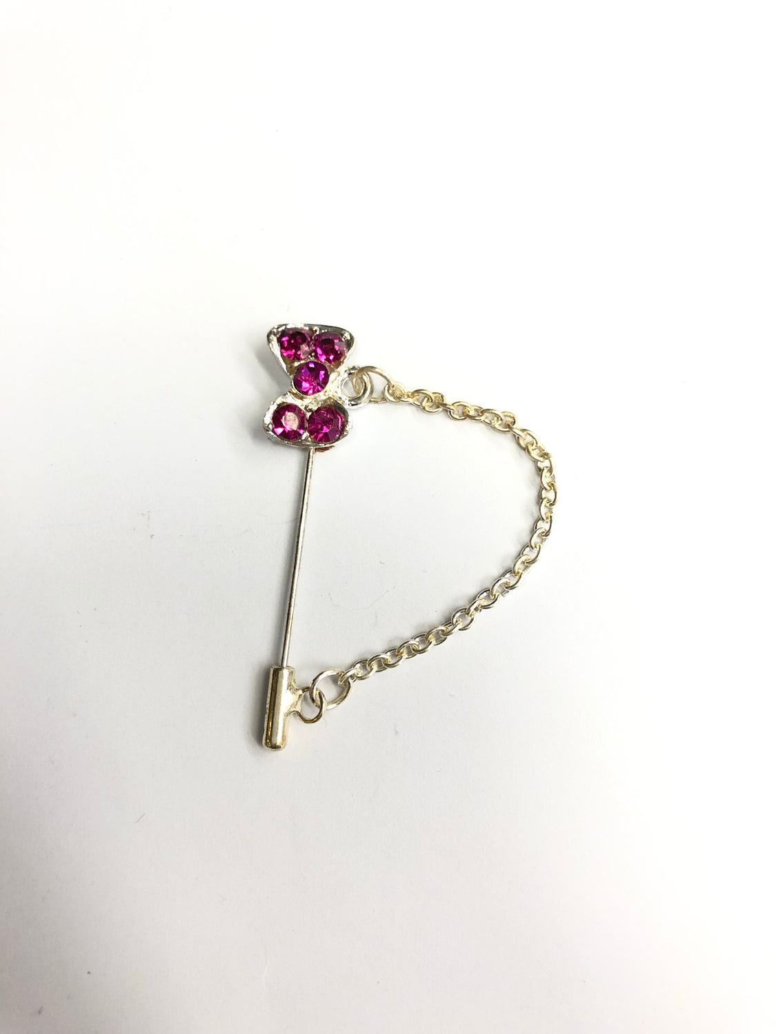 silver clasp pin with hot pink bow jewel and a chain
