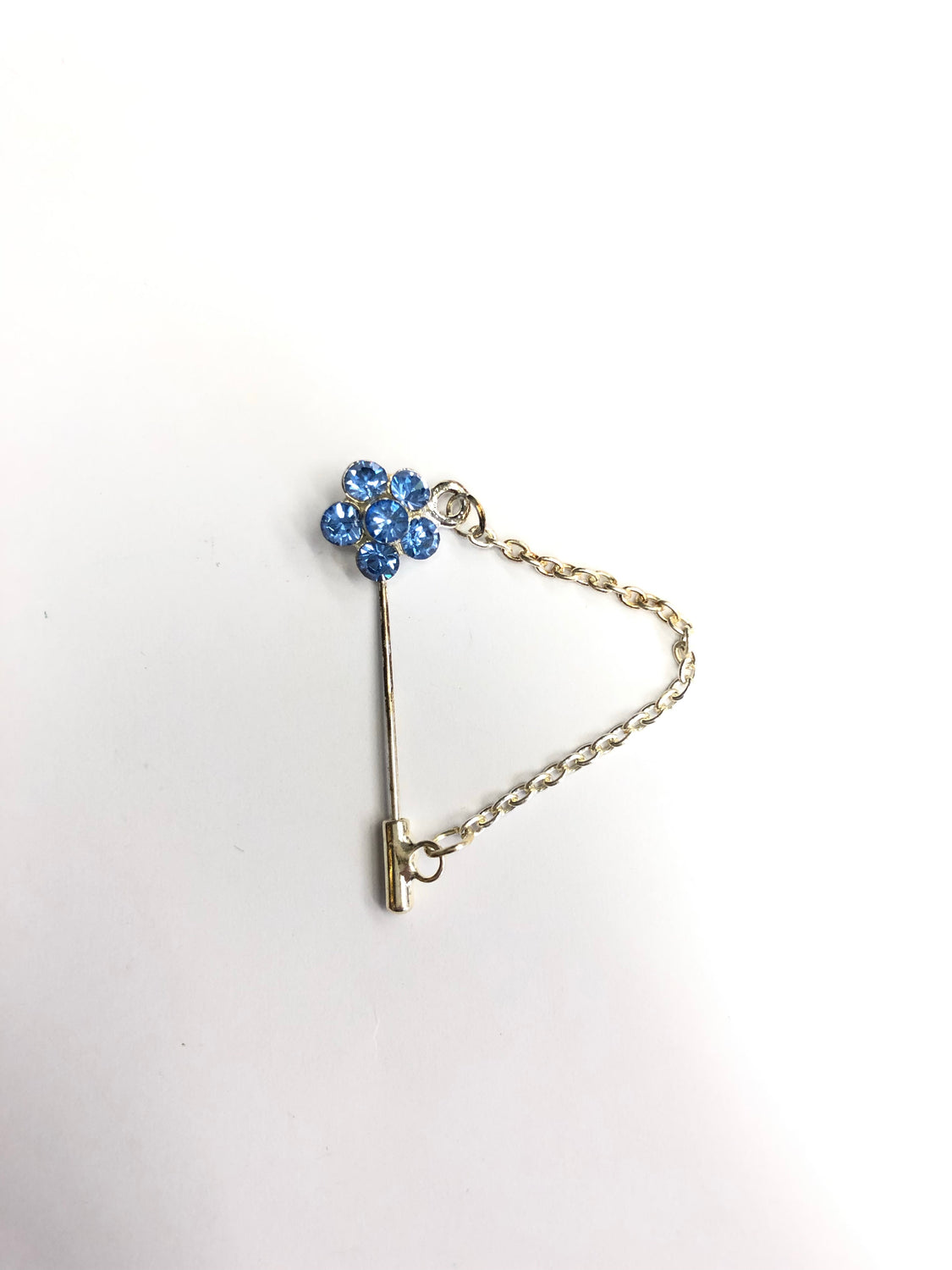 silver clasp pin with blue floral jewel and a chain