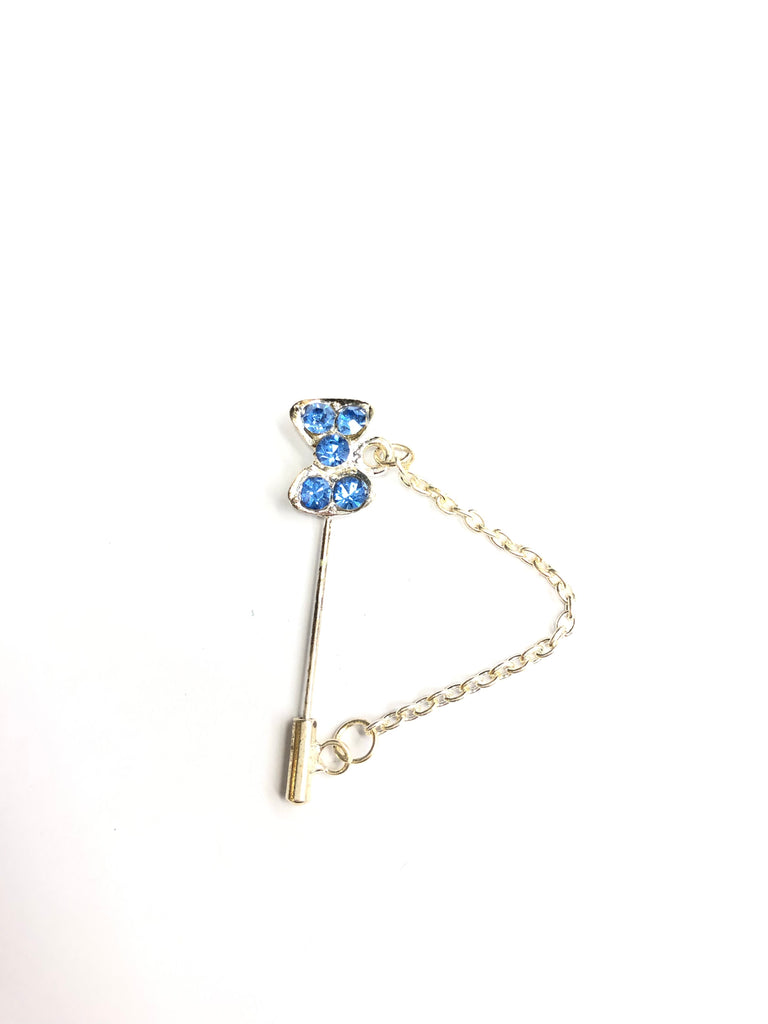 silver clasp pin with blue bow jewel and a chain