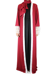 woman wearing an abaya in red embellished with lace sleeves and a matching hijab