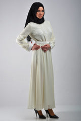 long sleeve maxi dress in white with pockets on the front and a waist tie